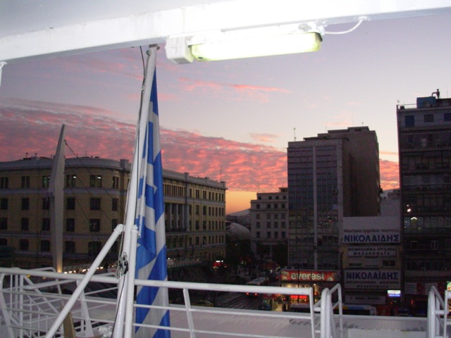 Sunrise over Piraeus seen from ferry stern